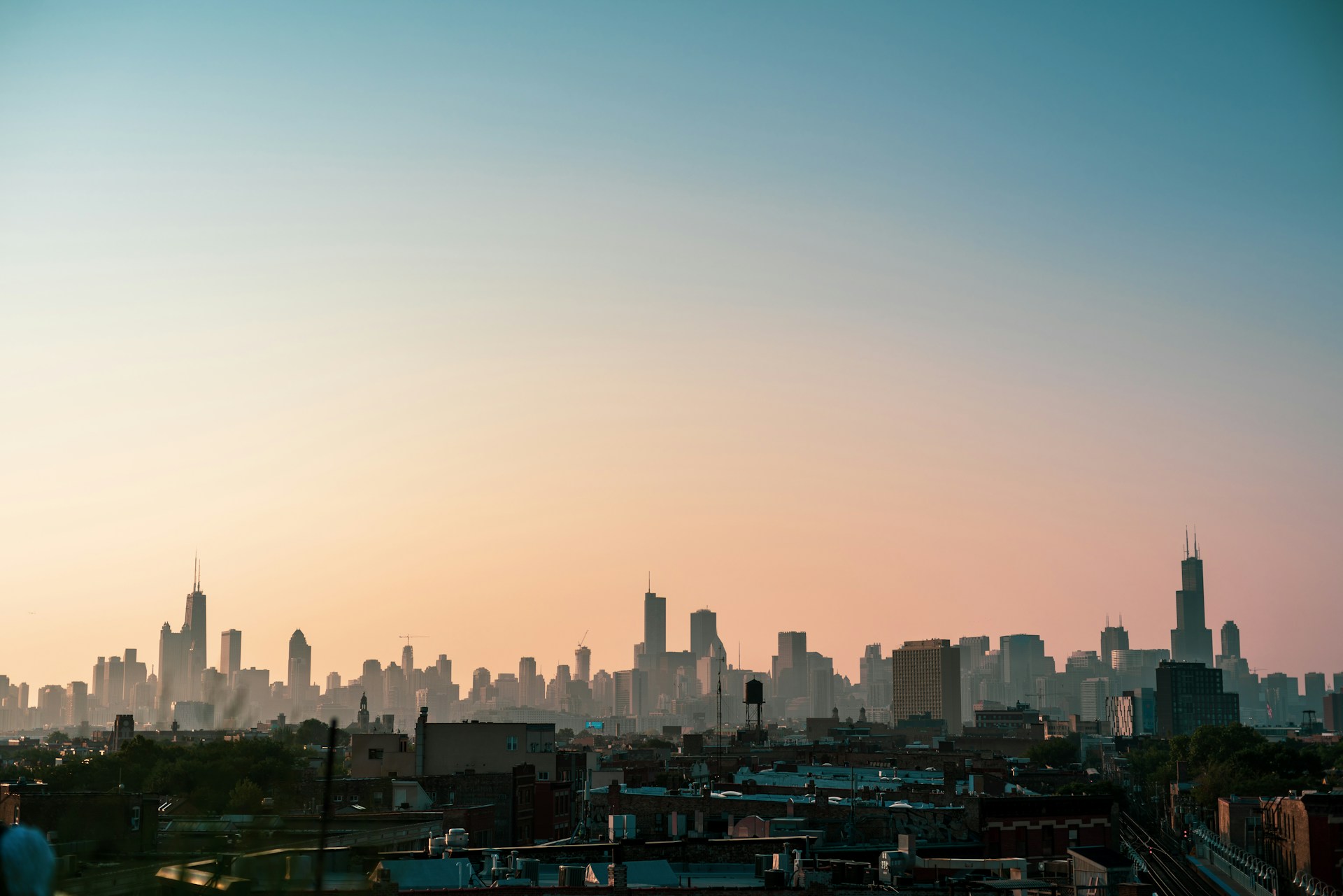 A photo of the Chicago skyline taken from the west at sunrise.